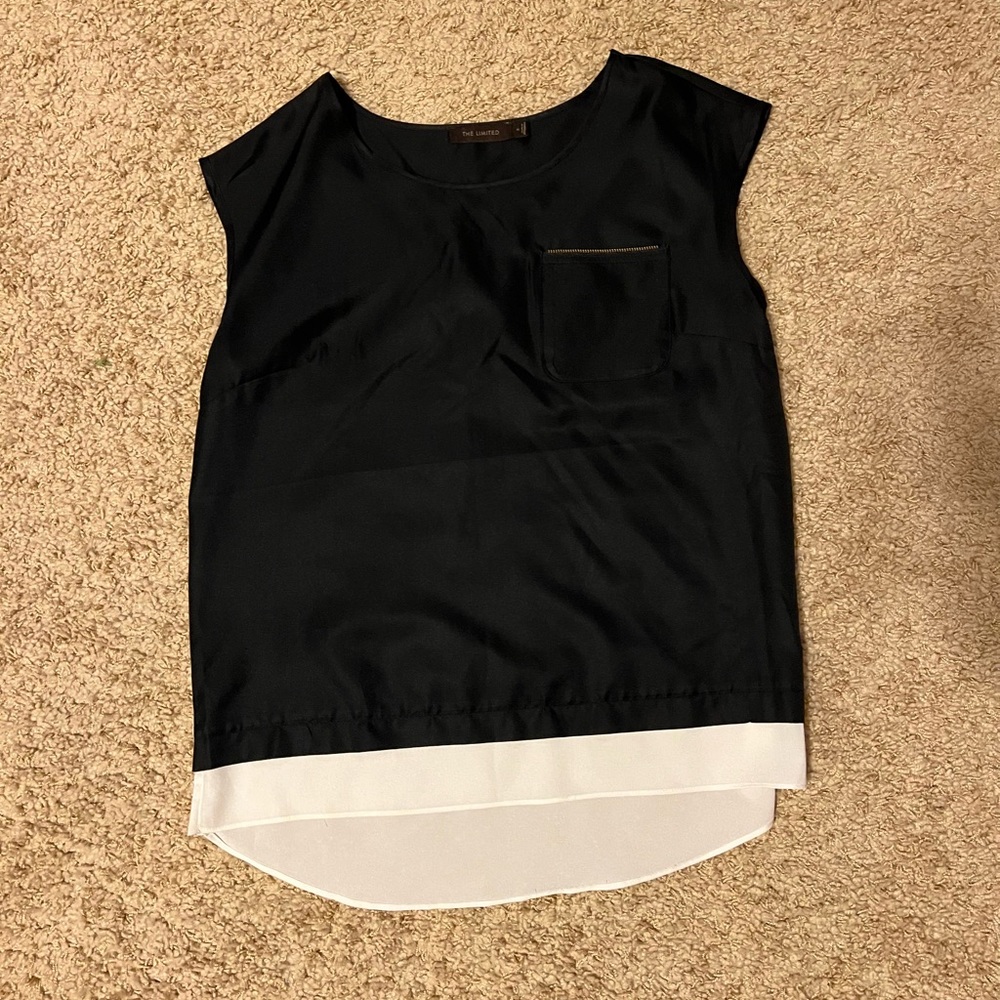 Sleeveless shirt with zipper detail above pocket.